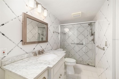 Step inside this beautifully remodeled 3rd-floor, 2-bedroom on IMG Academies Golf and Country Club in Florida - for sale on GolfHomes.com, golf home, golf lot