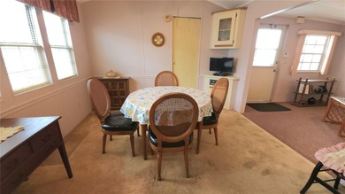 TWO BEDROOM, 1 1/2 BATHROOM MOBILE HOME IN ACTIVE 55+ COMMUNITY on River Run Golf Links in Florida - for sale on GolfHomes.com, golf home, golf lot