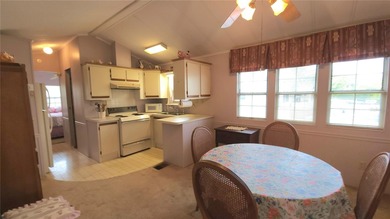 TWO BEDROOM, 1 1/2 BATHROOM MOBILE HOME IN ACTIVE 55+ COMMUNITY on River Run Golf Links in Florida - for sale on GolfHomes.com, golf home, golf lot