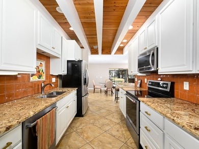 This exceptional lakefront gem is a nearly 2,000-square-foot on Gulf Gate Golf Club in Florida - for sale on GolfHomes.com, golf home, golf lot