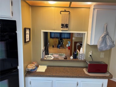 Move-in ready home in a desirable 55+ golf community overlooking on Zellwood Station Country Club in Florida - for sale on GolfHomes.com, golf home, golf lot