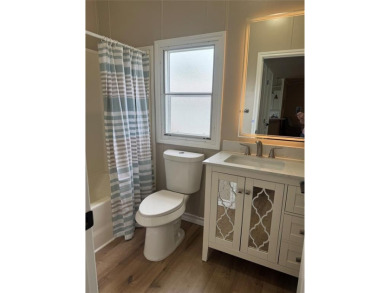 This is a newly remodeled mobile home in Horseshoe Bend Air Park on Horseshoe Bend Country Club in Texas - for sale on GolfHomes.com, golf home, golf lot