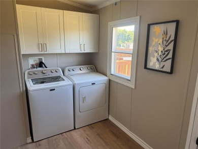 This is a newly remodeled mobile home in Horseshoe Bend Air Park on Horseshoe Bend Country Club in Texas - for sale on GolfHomes.com, golf home, golf lot