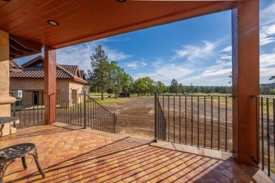 Passing through a custom lava rock gated entry to the impressive on Fall River Valley Golf and Country Club in California - for sale on GolfHomes.com, golf home, golf lot