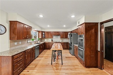 Stunning 1.5-story estate offering 4 bedrooms, 4.1 baths, a 2 on Country Club of Blue Springs in Missouri - for sale on GolfHomes.com, golf home, golf lot