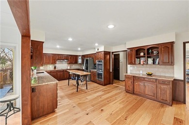 Stunning 1.5-story estate offering 4 bedrooms, 4.1 baths, a 2 on Country Club of Blue Springs in Missouri - for sale on GolfHomes.com, golf home, golf lot