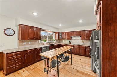 Stunning 1.5-story estate offering 4 bedrooms, 4.1 baths, a 2 on Country Club of Blue Springs in Missouri - for sale on GolfHomes.com, golf home, golf lot