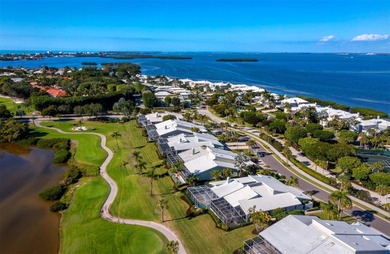 Positioned along the par-5 fairway with tranquil lake views on Longboat Key Golf Club Resort in Florida - for sale on GolfHomes.com, golf home, golf lot