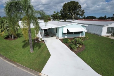 Coastal style home features metal roof & newer A/C and Golf on Barefoot Bay Golf Course in Florida - for sale on GolfHomes.com, golf home, golf lot