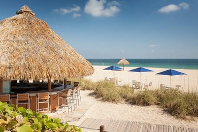 Enjoy ocean & city views from the expansive terrace of this on Coral Ridge Country Club in Florida - for sale on GolfHomes.com, golf home, golf lot