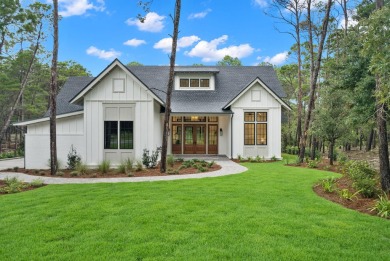 This stunning NEW CONSTRUCTION home Wild Heron is a single level on Sharks Tooth Golf Club in Florida - for sale on GolfHomes.com, golf home, golf lot