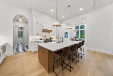 This stunning NEW CONSTRUCTION home Wild Heron is a single level on Sharks Tooth Golf Club in Florida - for sale on GolfHomes.com, golf home, golf lot
