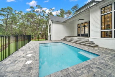 This stunning NEW CONSTRUCTION home Wild Heron is a single level on Sharks Tooth Golf Club in Florida - for sale on GolfHomes.com, golf home, golf lot