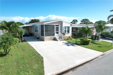 2022 Model home features accordion hurricane shutters, double on Barefoot Bay Golf Course in Florida - for sale on GolfHomes.com, golf home, golf lot