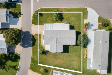 Inviting Triple Wide home on roomy corner double lot. Spacious on Barefoot Bay Golf Course in Florida - for sale on GolfHomes.com, golf home, golf lot