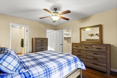 Set on a quiet street with peaceful views of Tradewinds Lake on Harbour Point Golf Club in North Carolina - for sale on GolfHomes.com, golf home, golf lot