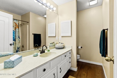 Set on a quiet street with peaceful views of Tradewinds Lake on Harbour Point Golf Club in North Carolina - for sale on GolfHomes.com, golf home, golf lot