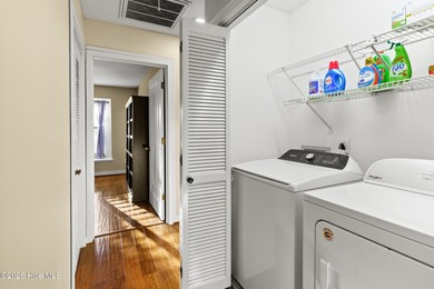 Set on a quiet street with peaceful views of Tradewinds Lake on Harbour Point Golf Club in North Carolina - for sale on GolfHomes.com, golf home, golf lot