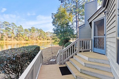 Set on a quiet street with peaceful views of Tradewinds Lake on Harbour Point Golf Club in North Carolina - for sale on GolfHomes.com, golf home, golf lot