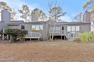 Set on a quiet street with peaceful views of Tradewinds Lake on Harbour Point Golf Club in North Carolina - for sale on GolfHomes.com, golf home, golf lot