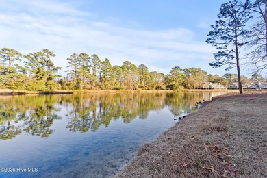 Set on a quiet street with peaceful views of Tradewinds Lake on Harbour Point Golf Club in North Carolina - for sale on GolfHomes.com, golf home, golf lot