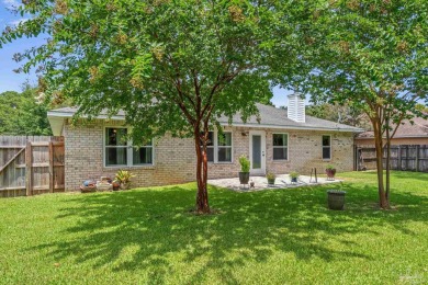 Blooming Crepe Myrtles greet you out front of this beautifully on Tiger Point Golf and Country Club in Florida - for sale on GolfHomes.com, golf home, golf lot