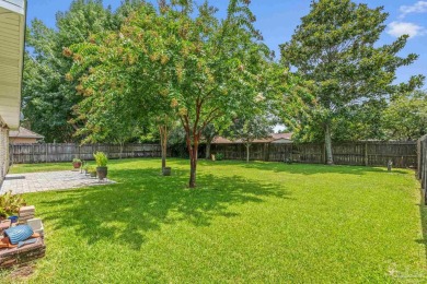 Blooming Crepe Myrtles greet you out front of this beautifully on Tiger Point Golf and Country Club in Florida - for sale on GolfHomes.com, golf home, golf lot