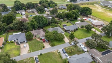 Blooming Crepe Myrtles greet you out front of this beautifully on Tiger Point Golf and Country Club in Florida - for sale on GolfHomes.com, golf home, golf lot