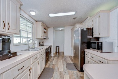 Immaculately maintained Palm Harbor home in picturesque Betmar on Betmar Acres Golf Club in Florida - for sale on GolfHomes.com, golf home, golf lot