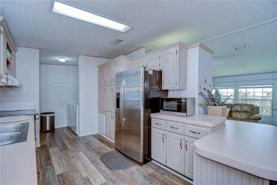 Immaculately maintained Palm Harbor home in picturesque Betmar on Betmar Acres Golf Club in Florida - for sale on GolfHomes.com, golf home, golf lot