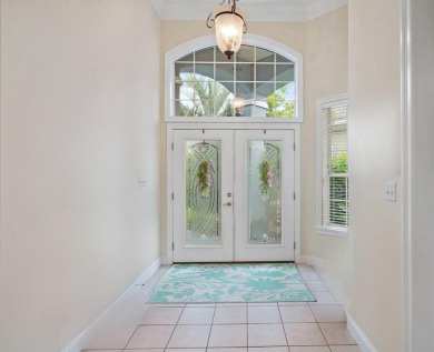 Welcome to this charming lakefront home in the private gated on Emerald Bay Golf Club in Florida - for sale on GolfHomes.com, golf home, golf lot