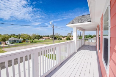 The home is elevated on pilings to allow for covered parking and on Rockport Country Club in Texas - for sale on GolfHomes.com, golf home, golf lot