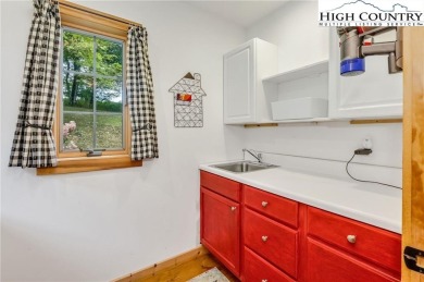 Welcome to your dream retreat. This charming log cabin is on Mountain Aire Golf Course in North Carolina - for sale on GolfHomes.com, golf home, golf lot