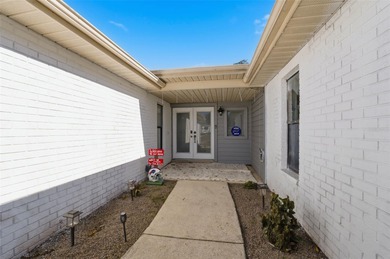 Tucked onto a generous 0.33-acre lot, this inviting 3-bedroom on Spring Hill Golf Course in Florida - for sale on GolfHomes.com, golf home, golf lot