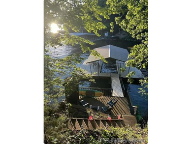 Discover lake living at its finest in the iconic Tan-Tar-A on The Oaks Golf Course in Missouri - for sale on GolfHomes.com, golf home, golf lot