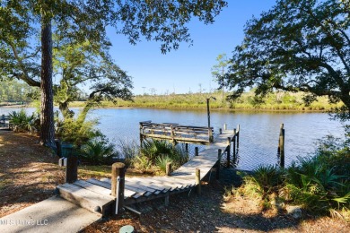 Welcome to this stunning 4-bedroom waterfront retreat, nestled on Diamondhead Country Club in Mississippi - for sale on GolfHomes.com, golf home, golf lot