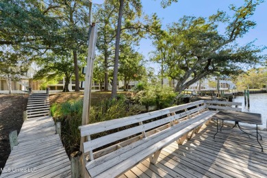 Welcome to this stunning 4-bedroom waterfront retreat, nestled on Diamondhead Country Club in Mississippi - for sale on GolfHomes.com, golf home, golf lot