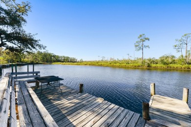 Welcome to this stunning 4-bedroom waterfront retreat, nestled on Diamondhead Country Club in Mississippi - for sale on GolfHomes.com, golf home, golf lot