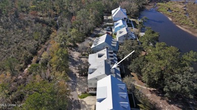 Welcome to this stunning 4-bedroom waterfront retreat, nestled on Diamondhead Country Club in Mississippi - for sale on GolfHomes.com, golf home, golf lot