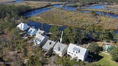 Welcome to this stunning 4-bedroom waterfront retreat, nestled on Diamondhead Country Club in Mississippi - for sale on GolfHomes.com, golf home, golf lot