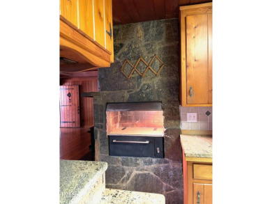No need to go the mountains!! This  picturesque original log on Carolina Trace Country Club in North Carolina - for sale on GolfHomes.com, golf home, golf lot