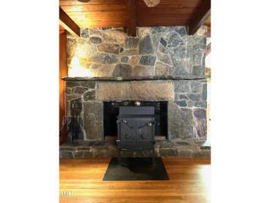 No need to go the mountains!! This  picturesque original log on Carolina Trace Country Club in North Carolina - for sale on GolfHomes.com, golf home, golf lot