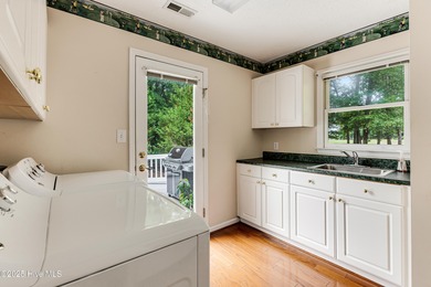 Tucked at the end of a cul-de-sac, this stunning brick home on Lockwood Folly Country Club in North Carolina - for sale on GolfHomes.com, golf home, golf lot