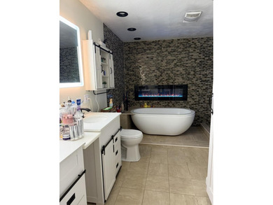 Welcome to this spacious and inviting 4-bedroom, 2.5-bath home on Paintsville Country Club in Kentucky - for sale on GolfHomes.com, golf home, golf lot