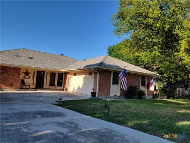 Enjoy a large main living room with a wood-burning fireplace on Hills of Cove Municipal Golf Course in Texas - for sale on GolfHomes.com, golf home, golf lot