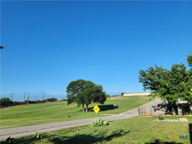 Enjoy a large main living room with a wood-burning fireplace on Hills of Cove Municipal Golf Course in Texas - for sale on GolfHomes.com, golf home, golf lot