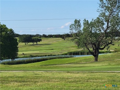 Enjoy a large main living room with a wood-burning fireplace on Hills of Cove Municipal Golf Course in Texas - for sale on GolfHomes.com, golf home, golf lot