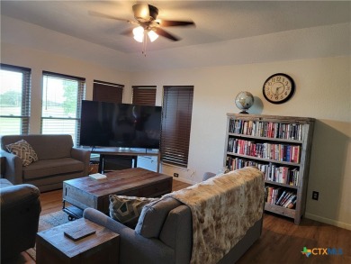 Enjoy a large main living room with a wood-burning fireplace on Hills of Cove Municipal Golf Course in Texas - for sale on GolfHomes.com, golf home, golf lot