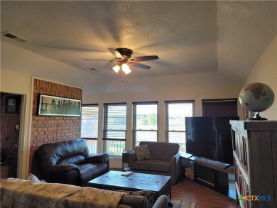 Enjoy a large main living room with a wood-burning fireplace on Hills of Cove Municipal Golf Course in Texas - for sale on GolfHomes.com, golf home, golf lot