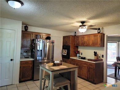 Enjoy a large main living room with a wood-burning fireplace on Hills of Cove Municipal Golf Course in Texas - for sale on GolfHomes.com, golf home, golf lot